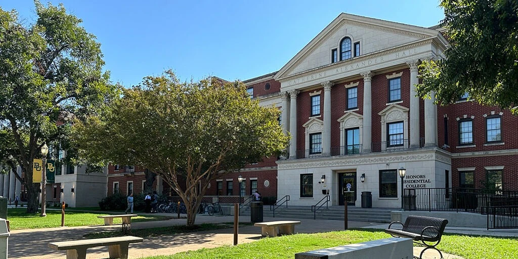 The image shows a classic brick building with white columns labeled "Honors Residential College" surrounded by trees and greenery.